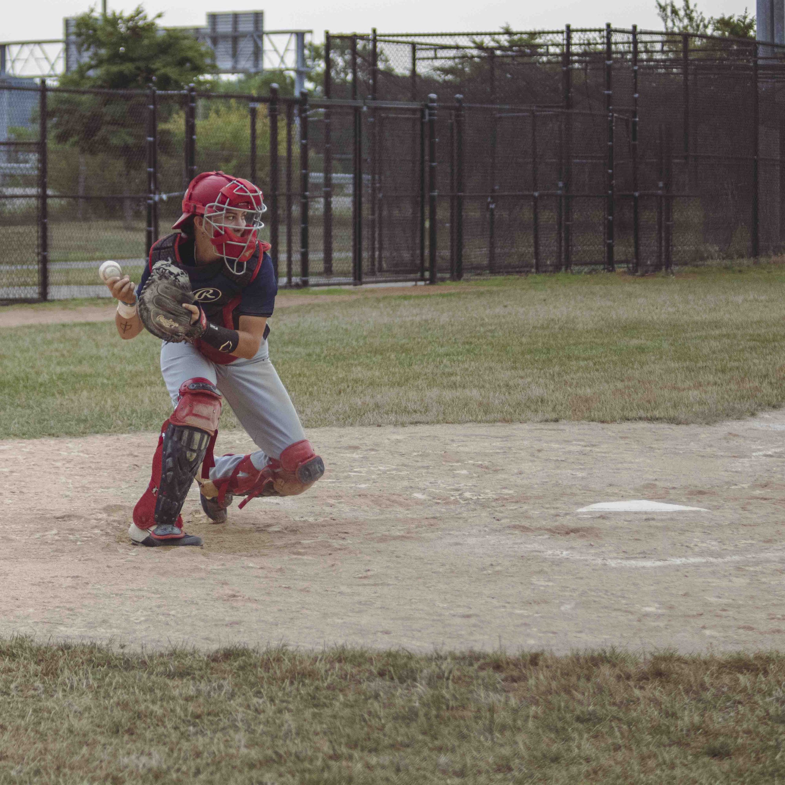 A baseball catcher about to throw the ball to the pitcher.